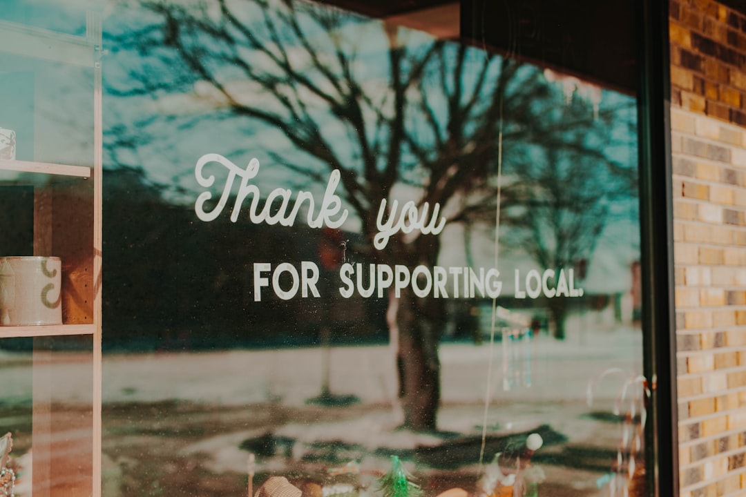 Window sign stating, thank you for supporting local